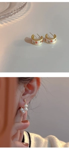 Detalle de pendientes de aro dorados con tulipán esmaltado y perlas en racimo