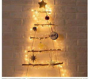 Wall-mounted rustic wooden Christmas tree with warm LED string lights and home ornaments