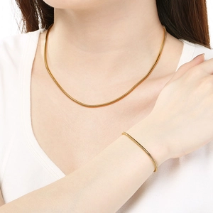 Polished gold 304 stainless steel snake chain necklace and bracelet set on model