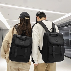 Large black minimalist nylon couple backpack with flip-top and dual leather buckle straps