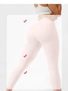Detail of high-waist yoga pants in light pink with ribbed texture and butt-lifting seam