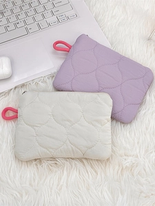 Quilted cotton organizer pouches in lavender and cream displayed with home office items