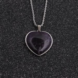 Hip hop heart necklace with dark purple gemstone and silver twisted chain on black background