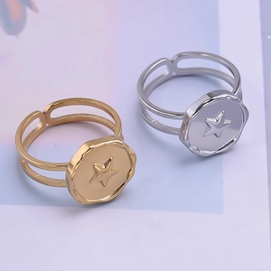 Detail of 18k gold and silver star rings showing adjustable double bands and star pattern