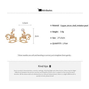 Detail showing materials and dimensions of the golden rocking horse pearl stud earrings