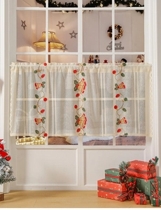 Detail of Christmas bell embroidery on semi-transparent lace cafe curtain on window