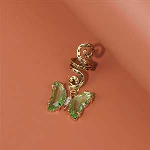 Detailed close-up of a golden snake hair cuff featuring a green crystal butterfly pendant