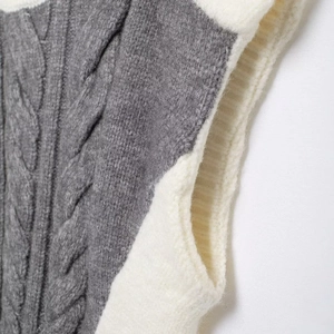 Women's crewneck knit vest in grey and beige contrast color with cable-knit texture