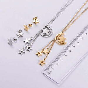 Macro view of moon and star tassel necklace pendant measuring 4cm with clear scale ruler