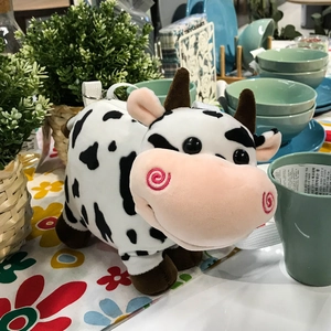 Cute cow plush shoulder bag for kids featuring black and white spots and pink muzzle