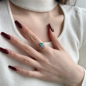 Detailed shot of double heart ring with blue zircon and silver cubic zirconia stones