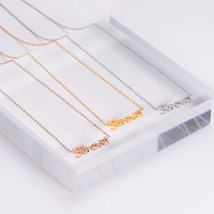 Three Forever letter necklaces in gold, silver, and rose gold with diamond accents
