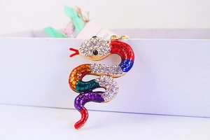 Macro shot of a colorful enamel snake keychain with sparkling rhinestones and gold plating
