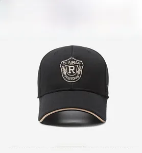 Detail of black baseball cap with shield embroidery and contrasting khaki brim edge