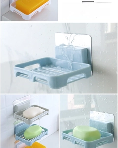 Close-up of wall-mounted drainage soap holder with adhesive strip and PP material