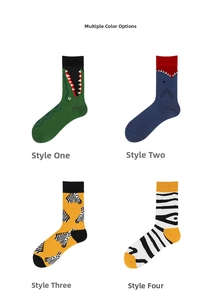 Detail view of four mid-calf socks with crocodile, shark, and zebra cartoon patterns