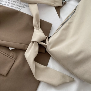 Japanese style minimalist beige crossbody bag with knotted strap and zipper detail
