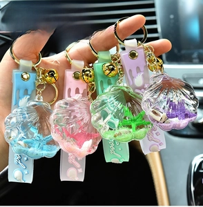 Close-up of acrylic shell oil-filled keychains in blue, pink, green, and purple shades
