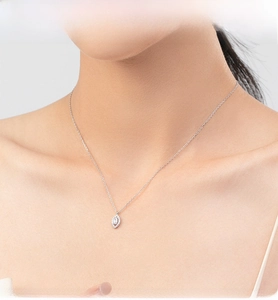 Detail view of s925 sterling silver eye necklace with marquise zircon on woman neck