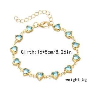 Detailed view of gold chain bracelet with light blue heart gems and size parameters