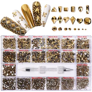 Detail of 21-grid nail art rhinestones kit with various golden crystals and picking tool