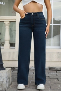 Close-up of high-waisted straight leg jeans in dark blue denim with washed texture