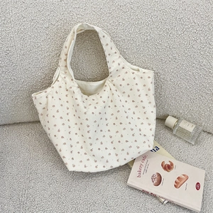 Close-up of corduroy tote bag with pink floral print and soft velvet texture detail