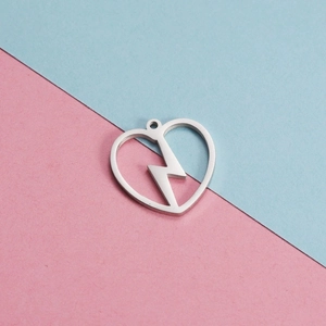 Sleek stainless steel heart and lightning bolt pendant on a dual-tone minimalist background