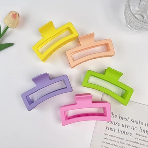 Flat lay of five 13cm matte hollow rectangle hair claws in assorted pastel colors