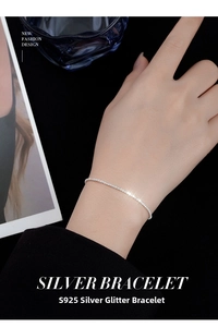 Close-up of S925 sterling silver shimmering chain bracelet worn on a female wrist