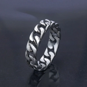 Macro view of polished silver stainless steel Cuban link chain ring for men and women
