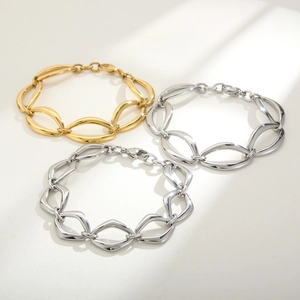 Detailed view of geometric mixed-metal chunky links in gold and silver finish