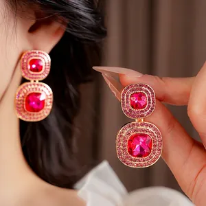 Vintage gold square earrings with rose red crystals and pink rhinestones on model