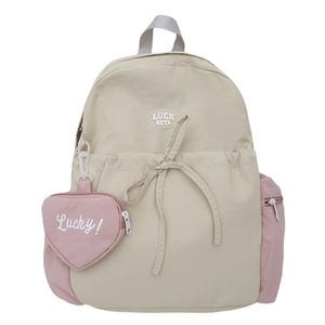 Minimalist beige and pink canvas backpack with heart-shaped charm and luck getl patch