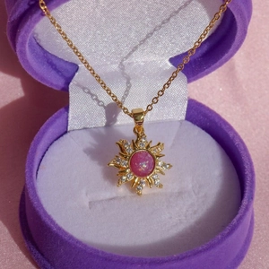 Rotating sunflower necklace with pink opal and zircon in purple velvet jewelry box