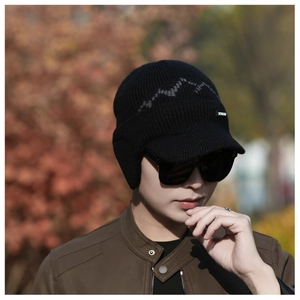 Detail of men's winter knit hat with ear flaps and gray wave pattern for cold weather