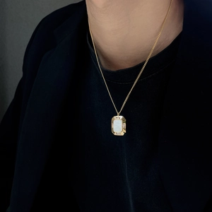 Elegant gold titanium steel necklace with rectangular white shell pendant on model