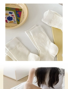 Detail of white mesh socks with bowknot and diamond patterns in a stylish flat lay