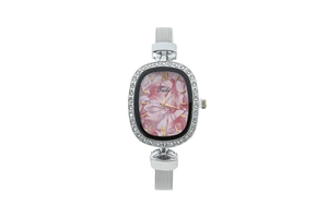 Detailed macro view of the oval pink marble dial and rhinestone bezel on a silver watch
