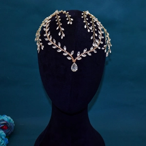 Detail of bridal headband with golden leaves, rhinestones and drop crystal pendant