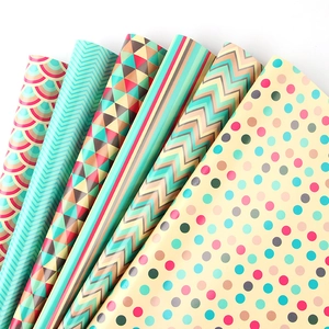 Colorful gift wrapping paper rolls with geometric patterns like chevron and dots