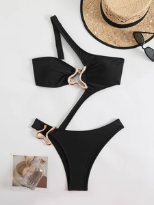 Detail view of black one-shoulder cutout swimsuit with luxury wavy gold metal buckles