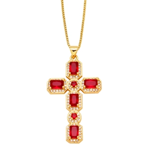 Close-up of golden cross necklace with red stones and micro-pave crystals on white background