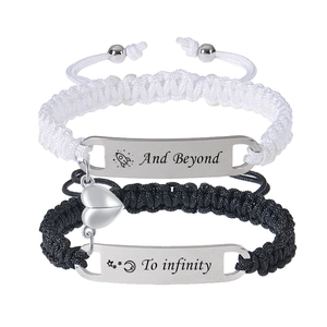 Detail of magnetic heart clasp on black and white woven rope couple bracelets