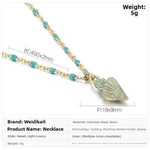 Macro detail of gold stainless steel necklace with blue resin beads and shell pendant
