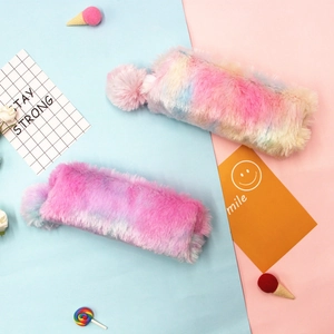Rainbow plush tie-dye pencil case with fluffy pompom charm on a colorful pastel background