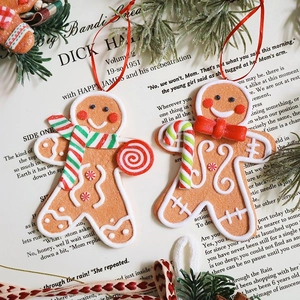 Resin gingerbread man Christmas ornaments with matte cookie texture on vintage book page
