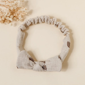 Detailed macro view of soft cotton baby headband featuring rainbow prints and a cute knot