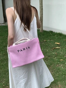 Pink striped canvas tote bag with Paris print and wide shoulder strap shown on model
