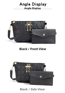 Detail view of black quilted heart texture bag with golden flamingo accent and small coin purse